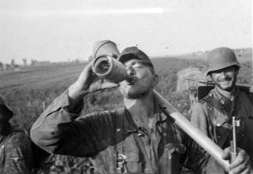 A Nederland soldier stops for a drink 