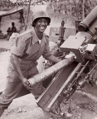 A Brazilian soldier prepares to load a 105mm howitzer