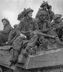 Riflemen riding a tank