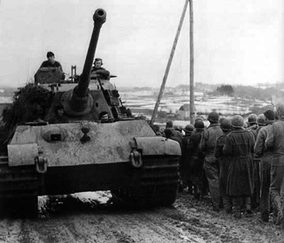 A Tiger II passes US prisoners