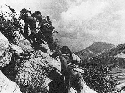 Poles clamber over the rugged hill around Cassino.