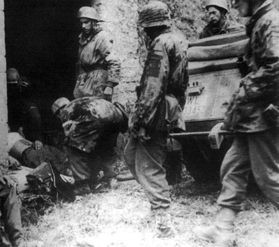 Men of the Waffen-SS and Fallschirmjäger look after the wounded