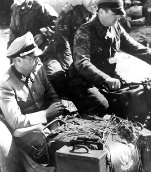 Kurt “Panzer” Meyer on his motorcycle with passenger Fritz Witt