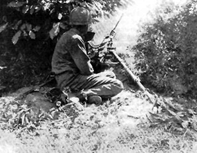 A .50cal machine-gun sets up in the bocage