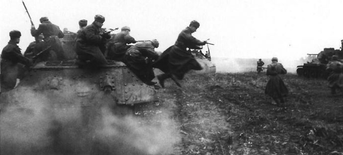 Soviet riflemen dismount from a T-34 tank