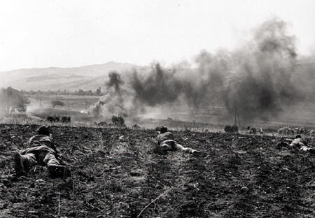 Canadians take up firing positions in a ploughed field Canadians take up firing positions in a ploughed field