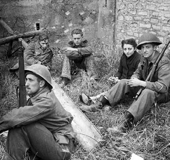 Canadian soldiers watch a French woman and German prisoners