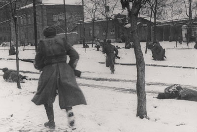 Soviet riflemen advance down a street