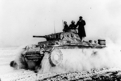 A Panzer III races into action arcoss the desert sands