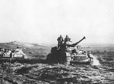 Panzer IV Gs advancing across the rough Tunisian terrain