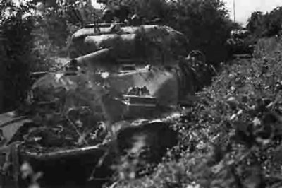Shermans advance down a bocage lined lane