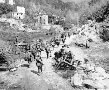 US troops move through a Sicilian village