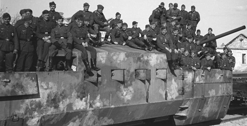 Victorious German infantry sit astride a captured Soviet armoured train artillery car