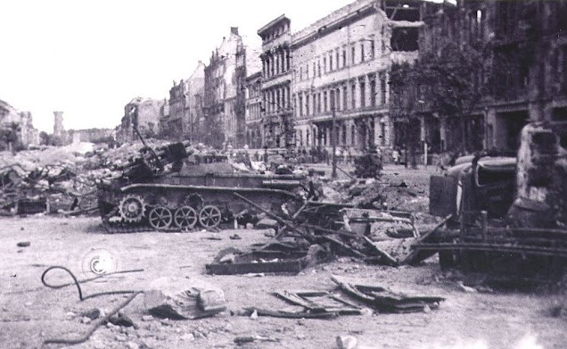 A wrecked Bedbug the rubble of street barricades behind it. Berlin 1945