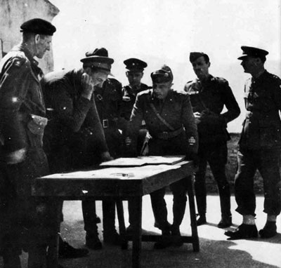 General Utili (centre hands of table) meets with Italian and British staff.