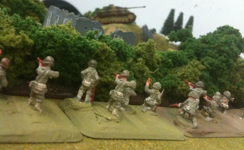 American Riflemen cautiously approach a Panzer on the ridge