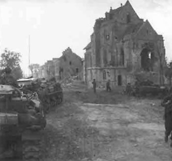 Tanks pass a bombed out church