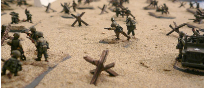 US infantry move up the beach