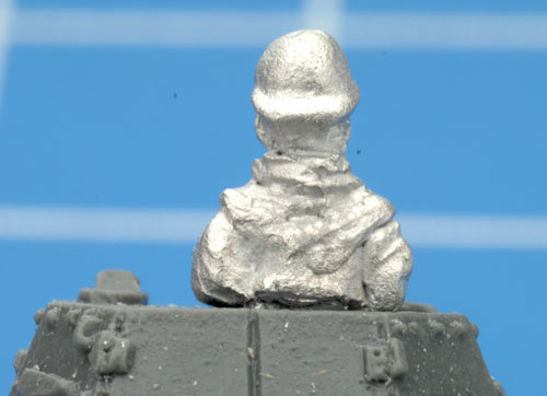The command figure sitting flush with the top of the turret