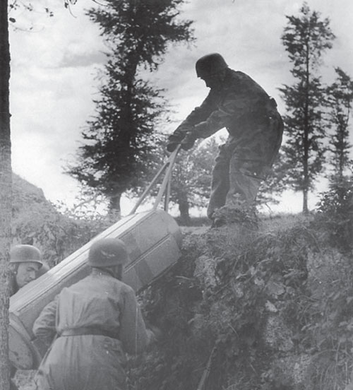 German Fallschirmjäger retrieve a drop canister